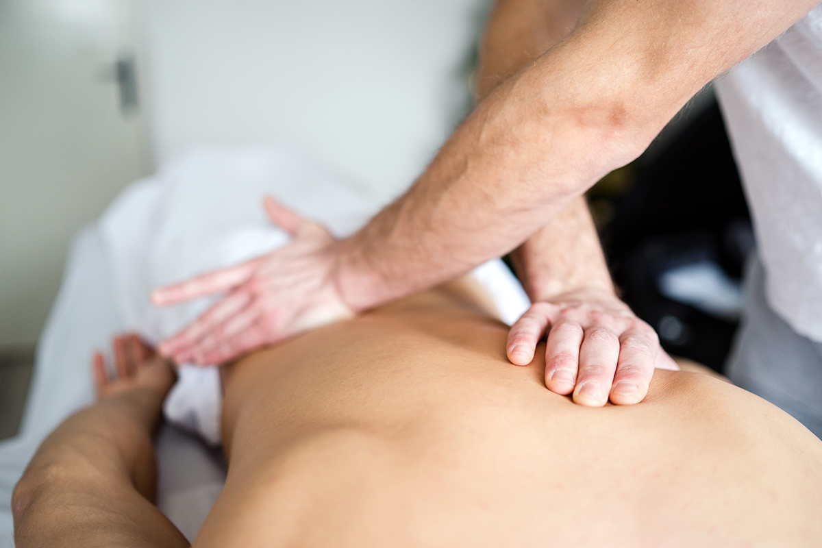 man getting massage in spa salon